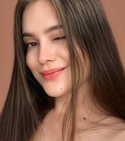OnlyMonster creator with long brown hair smiling to camera